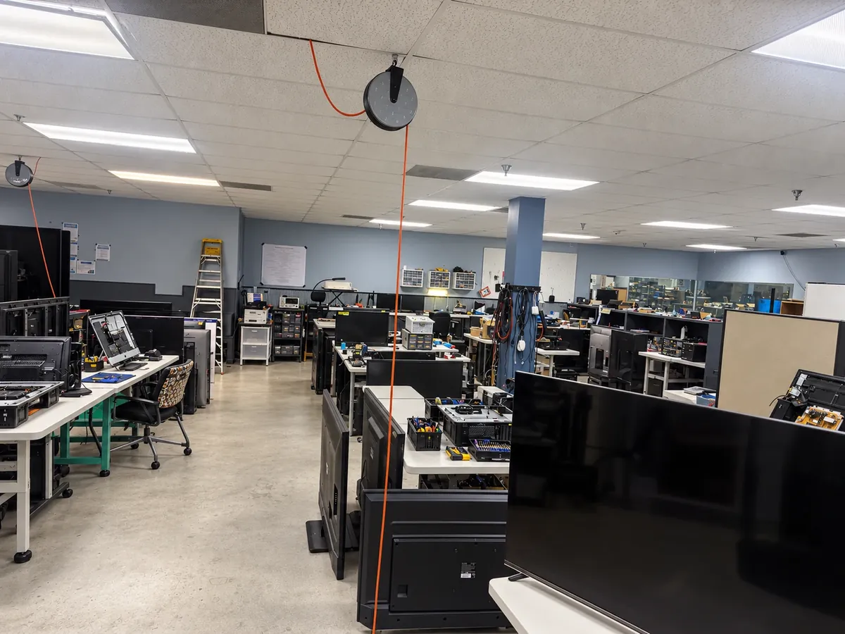 Budget Repair electronics workshop with TVs and computers on repair benches