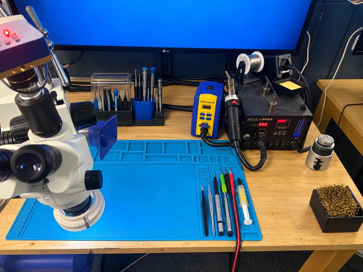 Microsoldering station with a stereo microscope, soldering iron, and hot air rework station